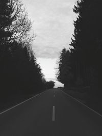 Road amidst trees against sky