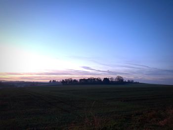 Scenic view of field against sky during sunset