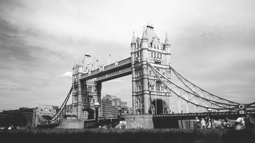 Low angle view of bridge against cloudy sky