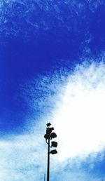 Low angle view of street light against blue sky