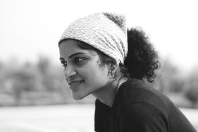 Portrait of smiling young woman looking away