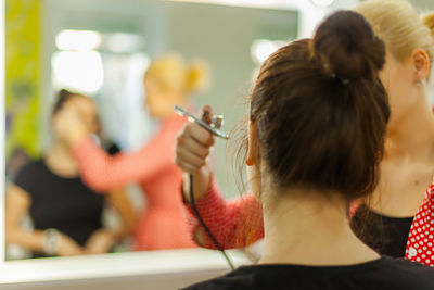 Beautician with customer in beauty spa