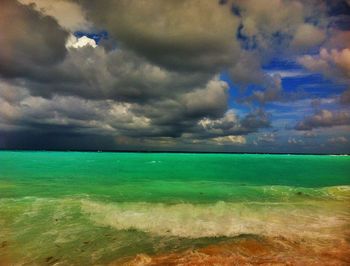 Scenic view of sea against cloudy sky
