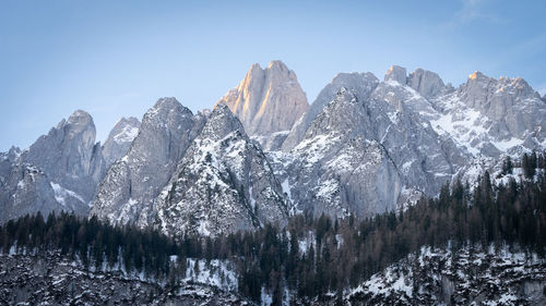 Rocky peak catching the first orange light during sunrise in austrian alps, austria, europe