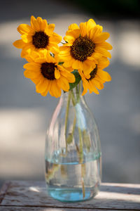 Close-up of yellow flower vase on table