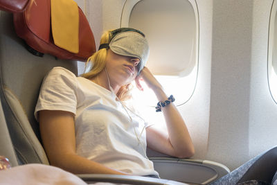 Young woman sitting in airplane