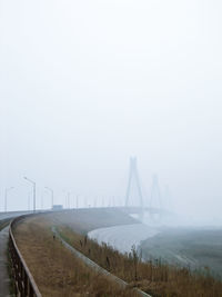 View of suspension bridge in foggy weather