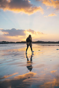 Full length of man standing on water against sky