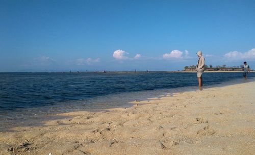 People at beach against sky. enjoy the vibes of beach on gili air island