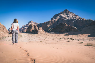 Women standing by rock