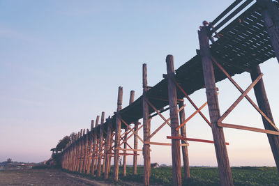 Low angle view of metallic structure on field against sky