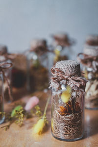 Close-up of potted plant on glass jar on table