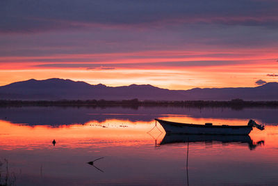 Scenic view of lake against romantic sky at sunset