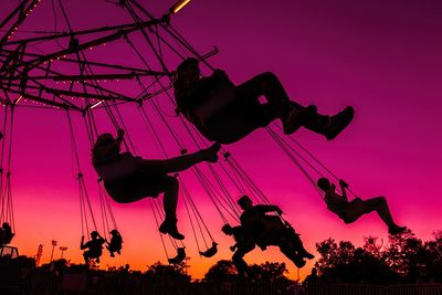 Low angle view of man photographing at dusk