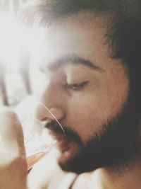 Close-up of young man drinking water