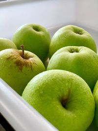 Close-up of granny smith apples in container