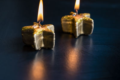 Close-up of lit candles on table