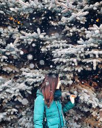 Woman standing on snow covered land