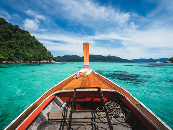 Long tail boat prow floating on scenic crystal clear turquoise sea. near koh lipe island, thailand.