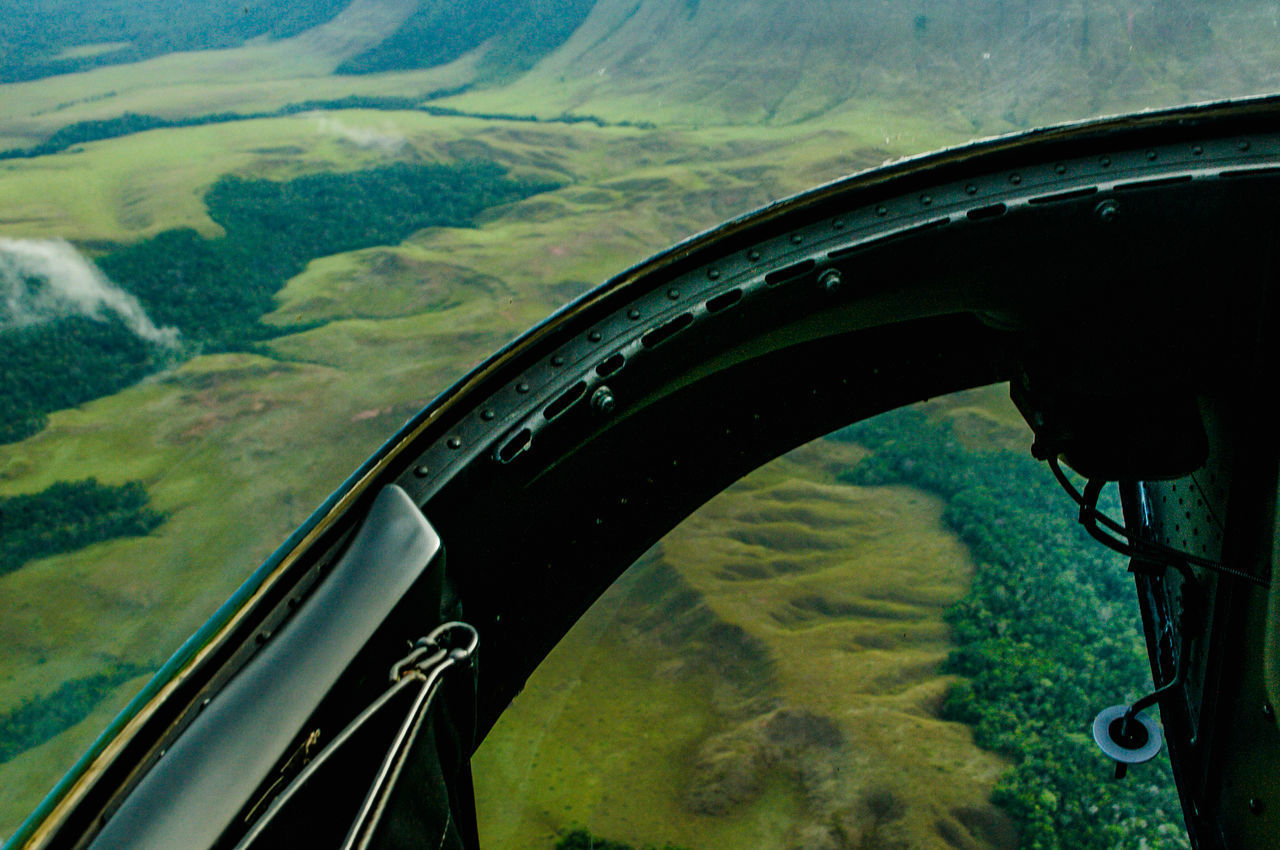 AERIAL VIEW OF LANDSCAPE THROUGH AIRPLANE WINDOW