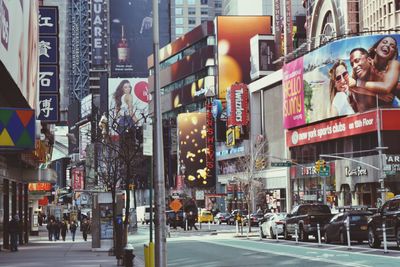 People walking on road along built structures