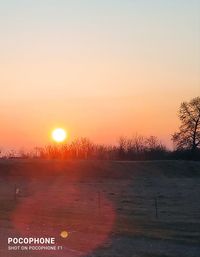 Scenic view of field against sky during sunset