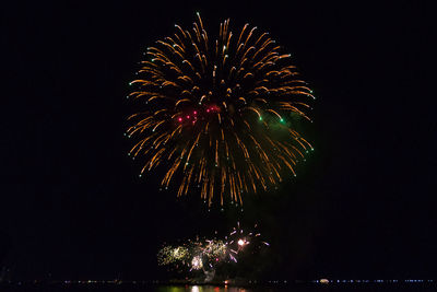 Low angle view of firework display at night