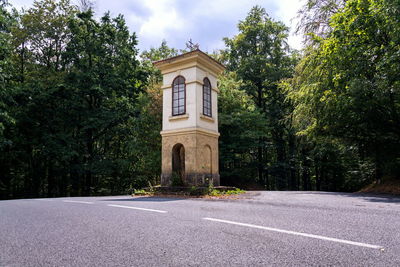 Road by building against sky