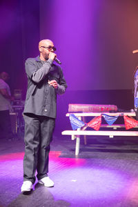 Full length of man standing on illuminated stage