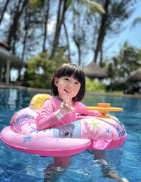 Portrait of young girl swimming in the pool 
