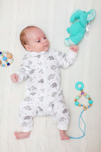 High angle view of baby playing with toy on floor