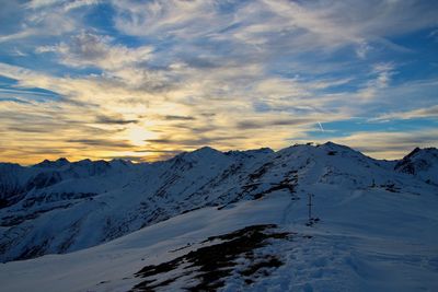 Scenic view of snowcapped mountains against sky during sunset