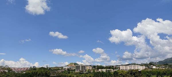 Panoramic shot of buildings against blue sky