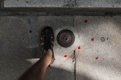 Low section of man standing on footpath