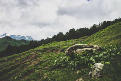 Scenic view of mountains against cloudy sky