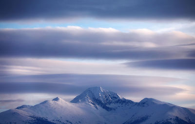 Scenic view of snowcapped mountains against sky during sunset