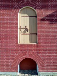 View of open door on brick wall