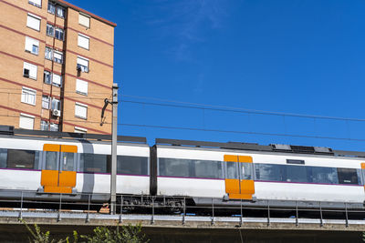 Commuter train on an elevated bridge in an apartment area in the city of hospitalet de llobregat 