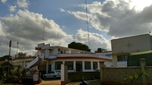 Buildings against cloudy sky