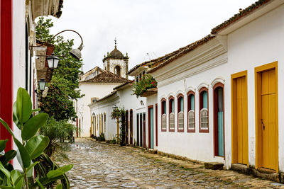 Old houses in colonial style with historic church in backgroud at paraty city