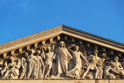 Low angle view of statue against blue sky