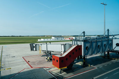 Airplane on airport runway against clear sky