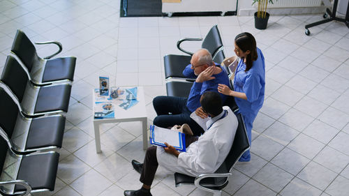 High angle view of people sitting on chairs