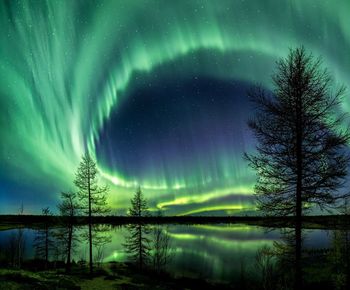 Scenic view of lake against sky at night