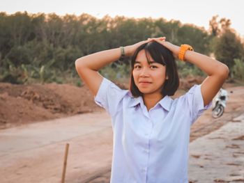 Portrait of a smiling girl standing outdoors