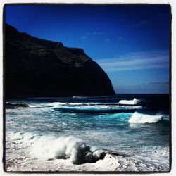 Scenic view of sea against clear blue sky