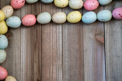 Full frame shot of multi colored eggs on wood