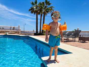 Full length of young man standing in swimming pool