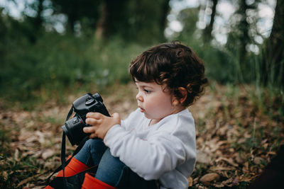 Rear view of child looking camera