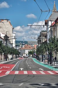 City street and buildings against sky